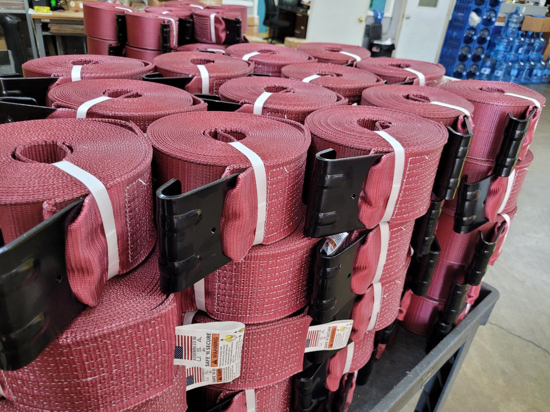 Close-up of a working load limit (WLL) tag sewn onto tie-down strap webbing