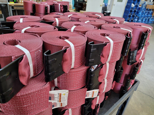 Close-up of a working load limit (WLL) tag sewn onto tie-down strap webbing